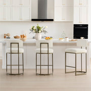 Bright and inviting kitchen space featuring leather bar stools, creating a perfect spot for casual meals and gatherings.