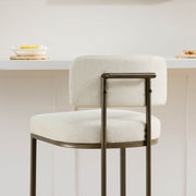 Angled back view: cream kitchen barstool showing frame detail.
