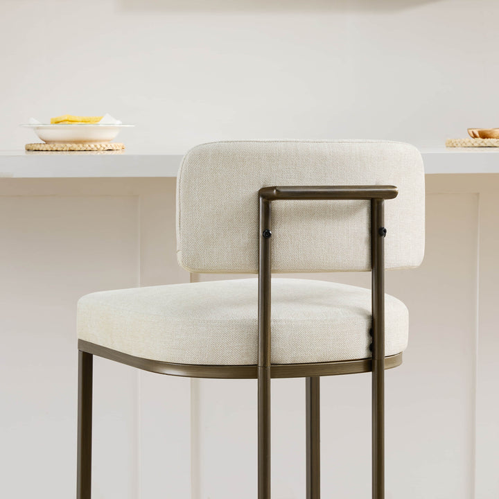 Angled back view: cream kitchen barstool showing frame detail.