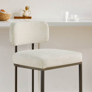 Close-up: cream fabric kitchen barstool, comfy seat & back.