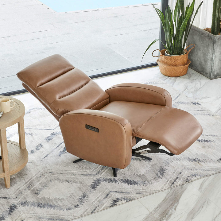 Landon Genuine Leather Power Swivel Recliner with Power Headrest in a cozy living space with a side table and a potted plant.