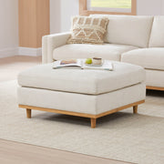 Liam modular ottoman in light fabric with wooden legs in a modern living room - CHITA Living