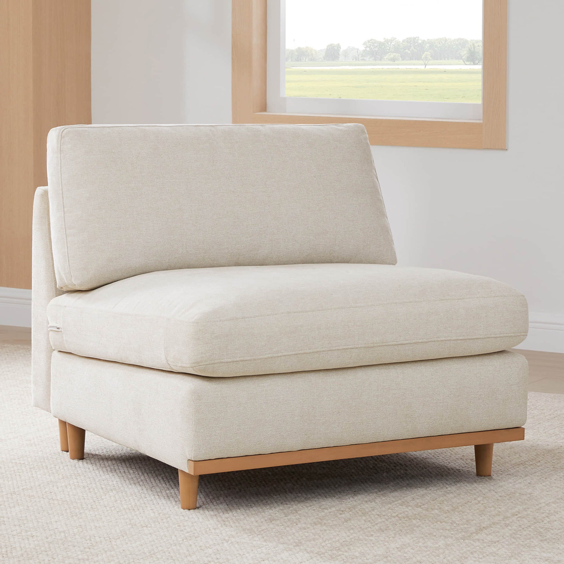 Liam modular sofa chaise in light fabric with wooden legs in a minimalist living space - CHITA Living