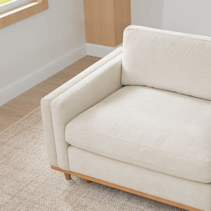 Close-up of Liam Sectional sofa cushion and wooden base in bright living room - CHITA Living