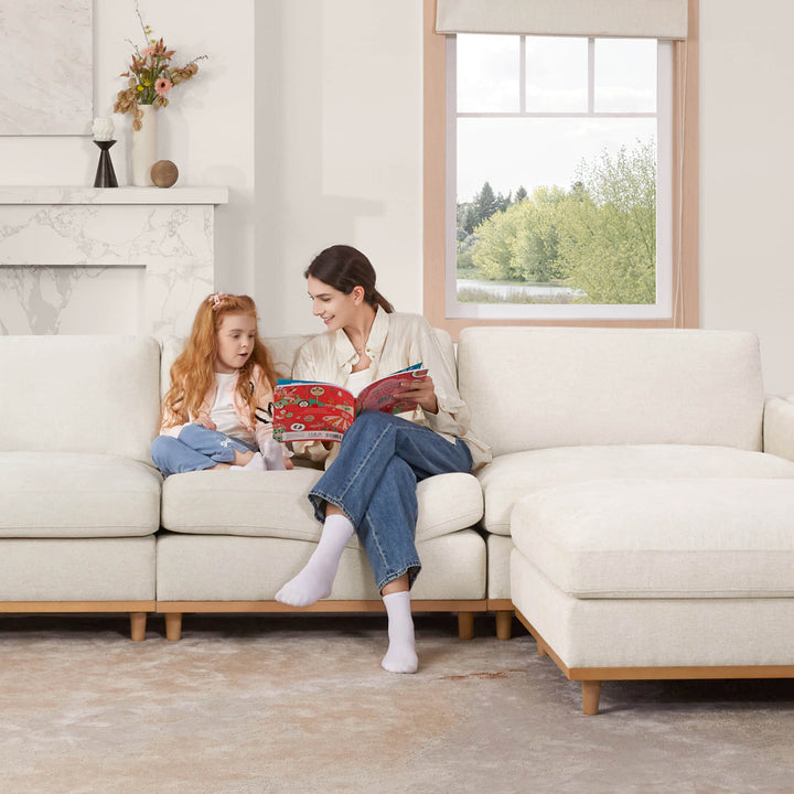Mother and daughter reading on Liam sectional sofa in a bright, modern living room - CHITA Living