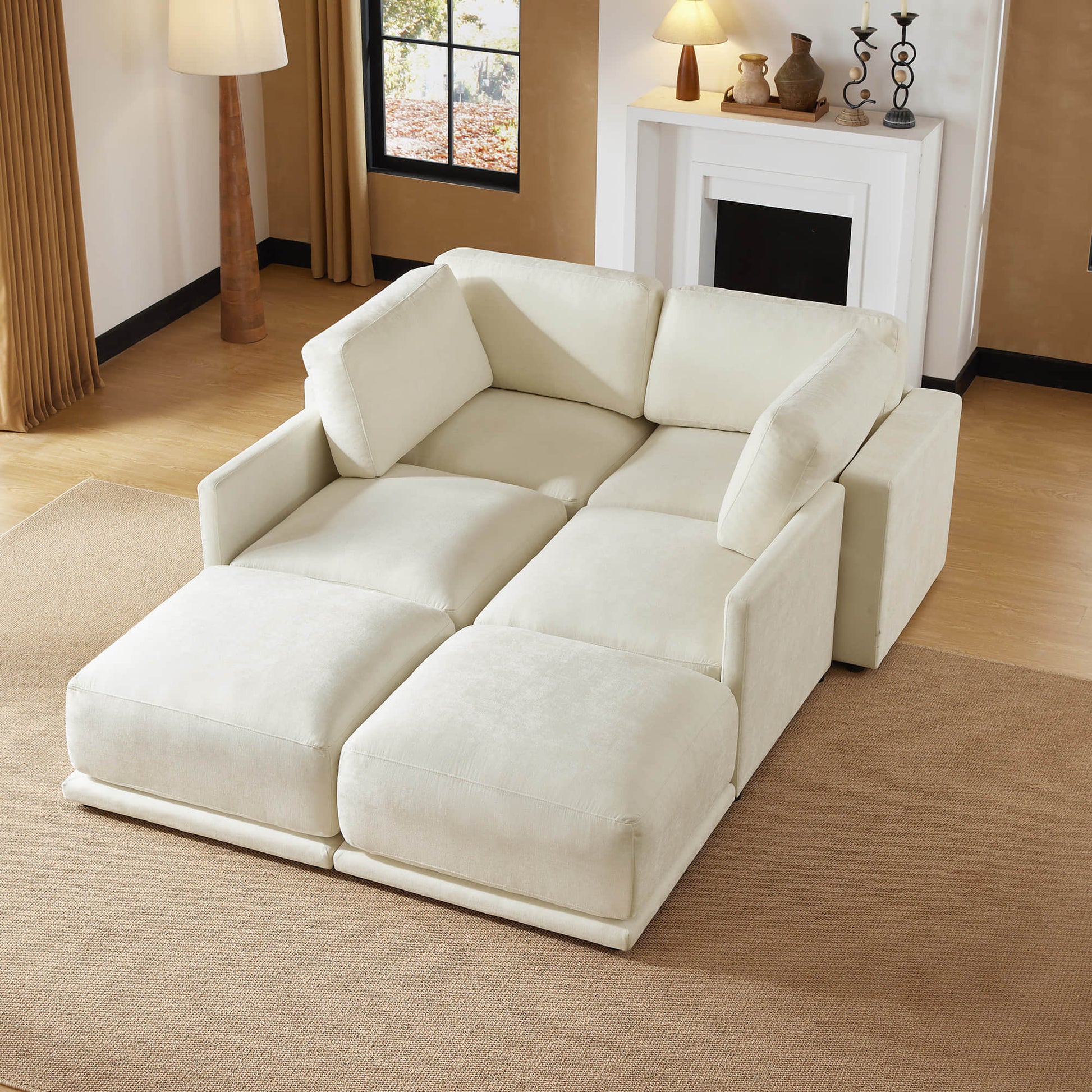 Cozy living space featuring a convertible sectional sofa, styled as a comfortable bed. The room is adorned with soft lighting and earthy tones, creating a warm ambiance.