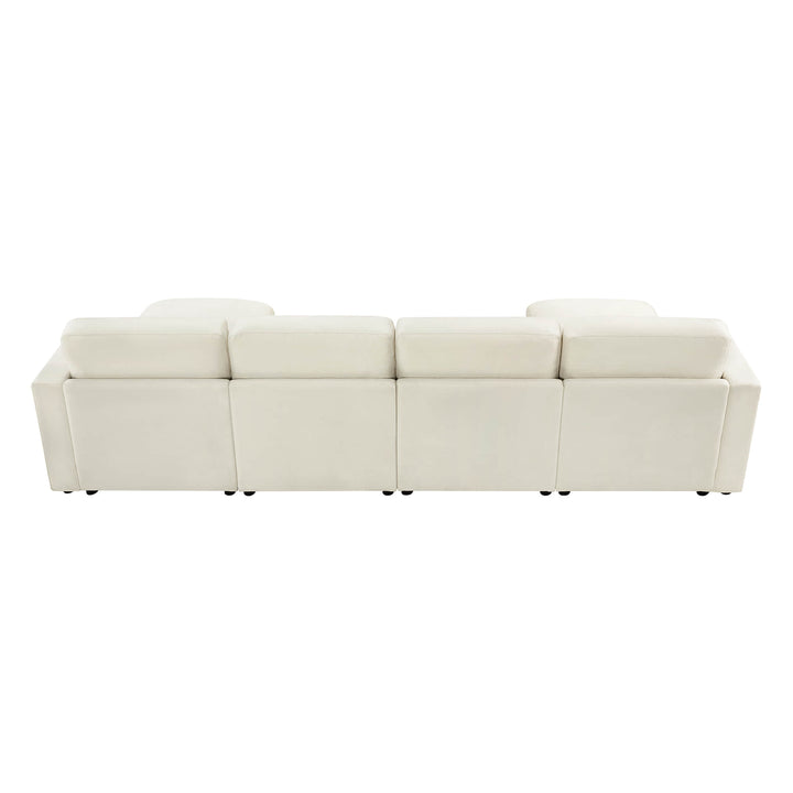 Rear view of a modern white sectional sofa, showing four back cushions aligned in a row.