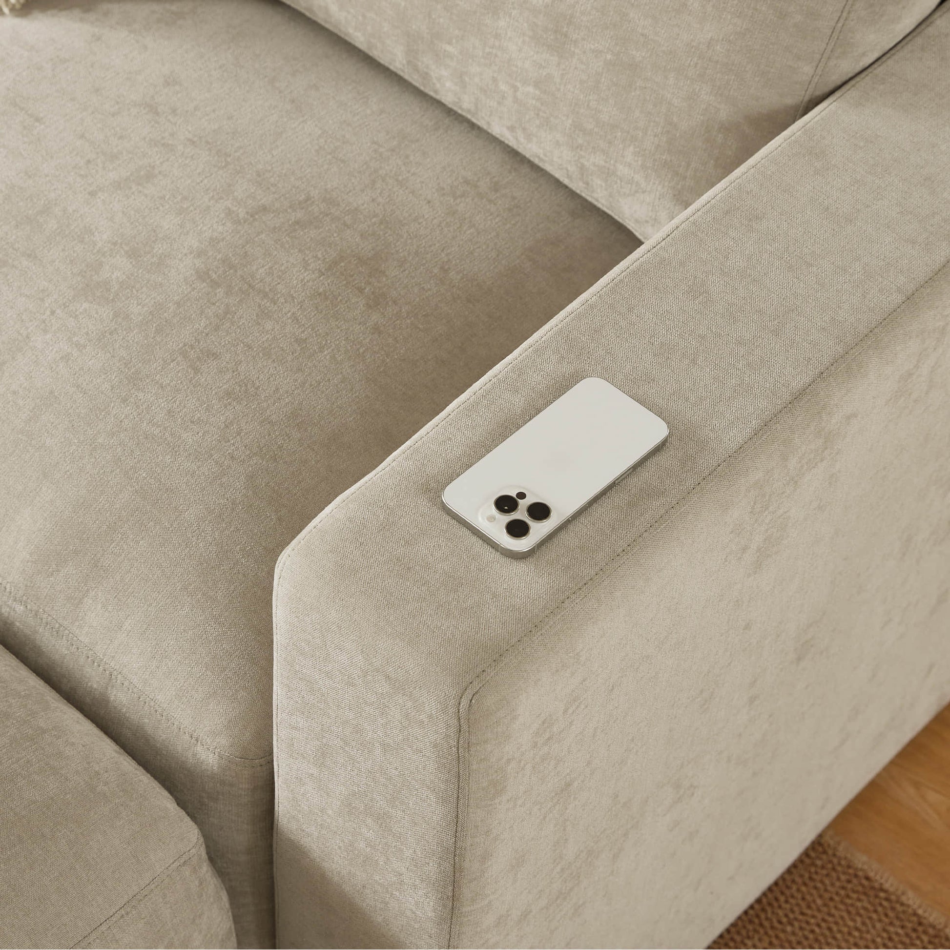 Mobile phone resting on chaise sectional arm