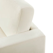Close-up view of the backrest and armrest of a modern white sofa, highlighting the smooth fabric and precise stitching.
