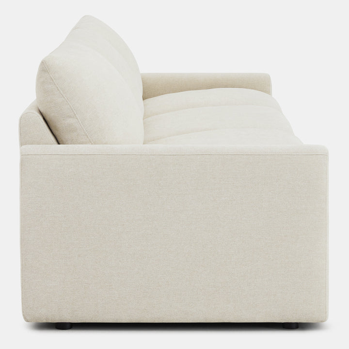 Side view of Ohana 3-Seat Motion Modular Sofa in light beige, emphasizing plush cushions - CHITA Living