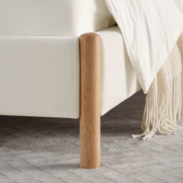 Close-up of light wooden leg on contemporary upholstered platform bed - CHITA Living