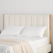 Serene upholstered bed headboard in cream fabric with wooden sides in a bright room - CHITA Living