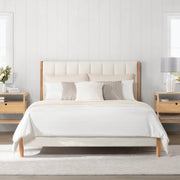 Modern full upholstered platform bed with light fabric headboard in bright bedroom - CHITA Living