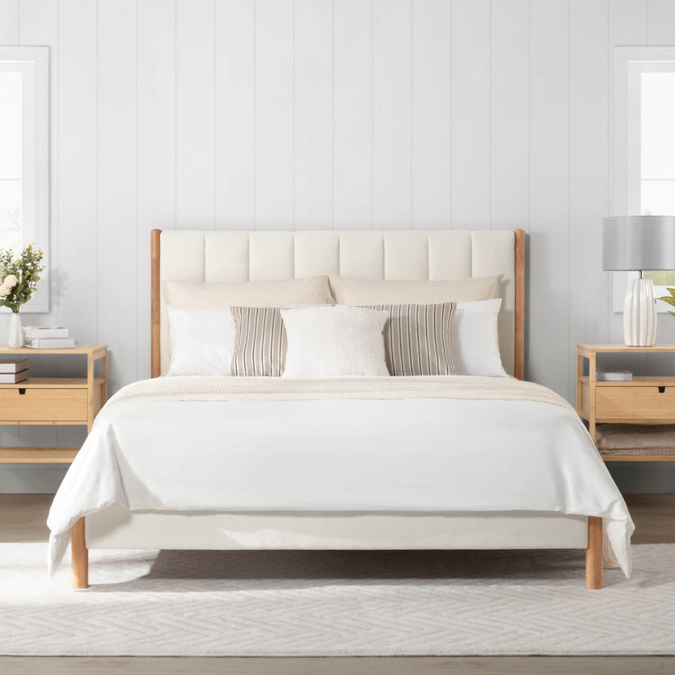 Modern full upholstered platform bed with light fabric headboard in bright bedroom - CHITA Living