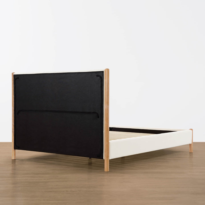 Back view of a modern upholstered platform bed with wooden frame and cushioned headboard - CHITA Living