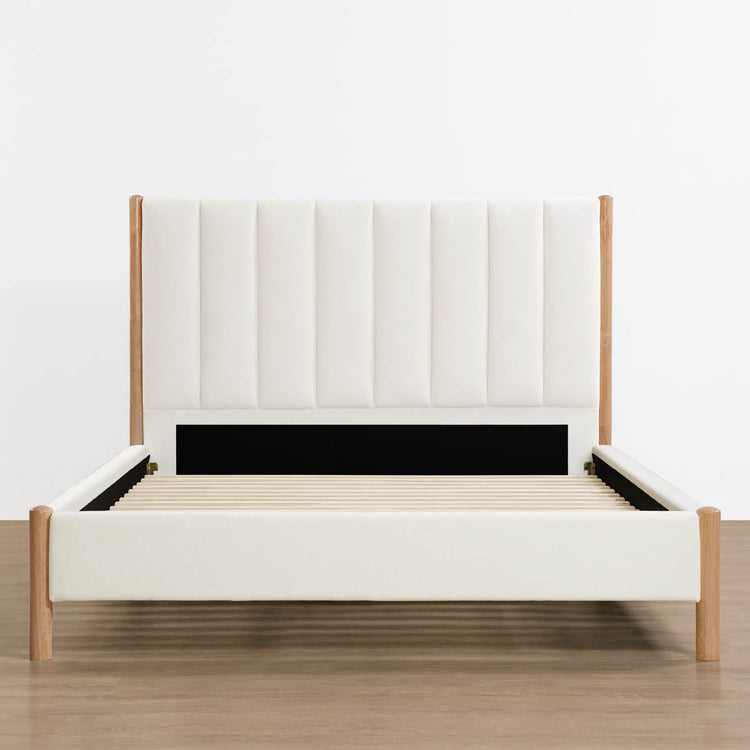 Modern upholstered platform bed with plush headboard and wooden frame in light setting - CHITA Living