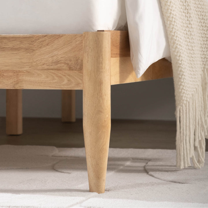 Close-up of natural wood legs of Solace Full Solid Wood Bed, showcasing quality craftsmanship - CHITA Living