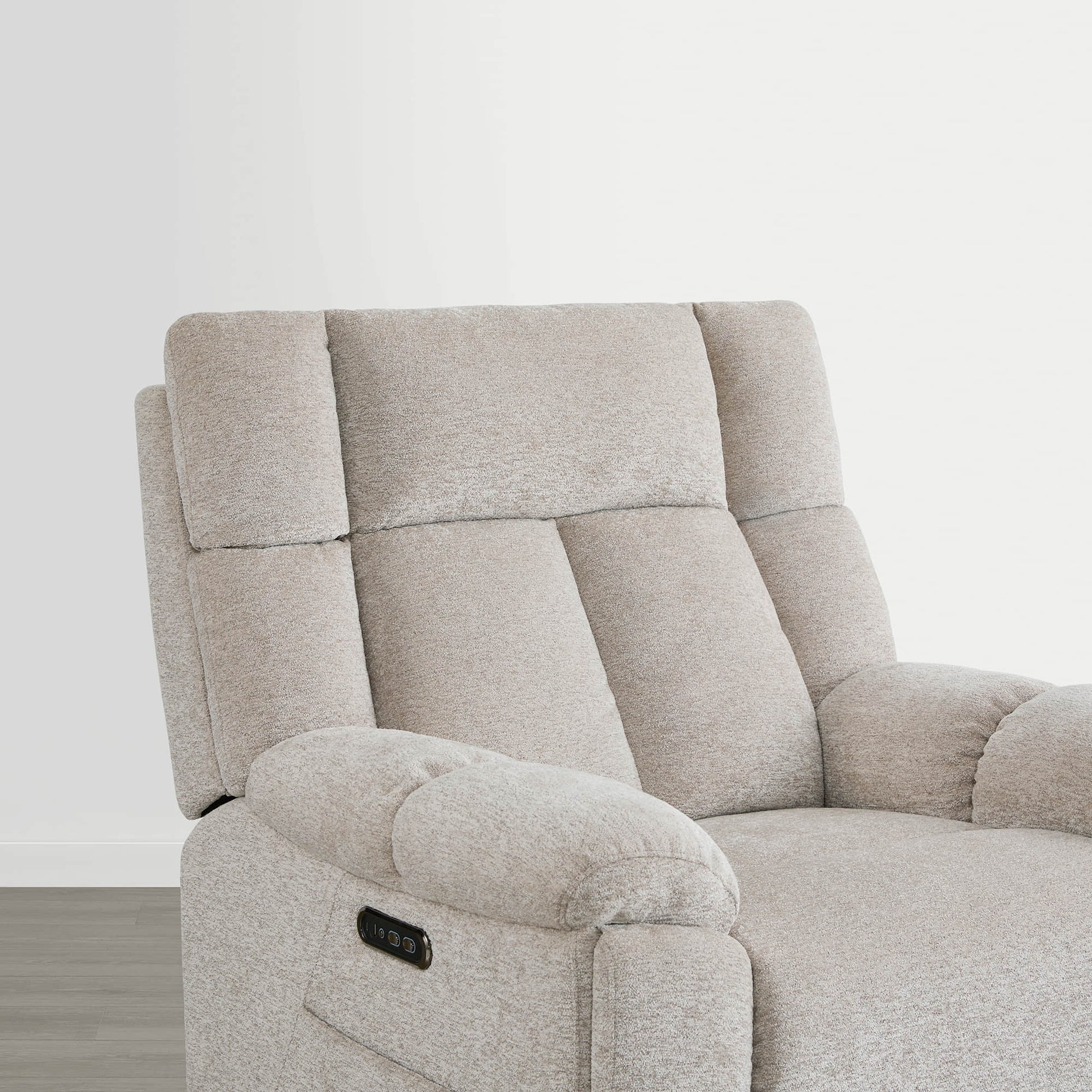 The Sonia Recliner, in beige fabric, features Bluetooth speakers and power lumbar support for ultimate comfort.