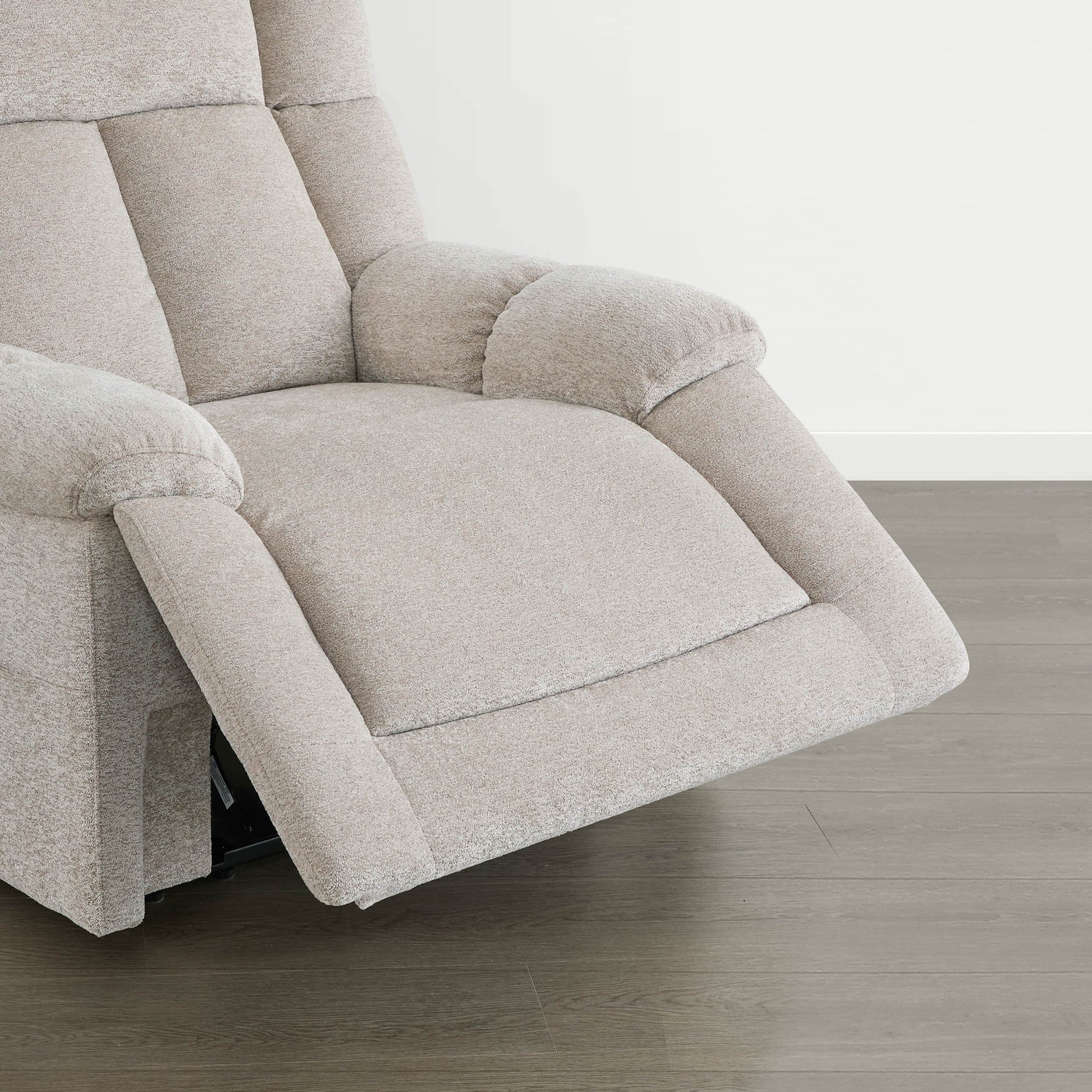 The Sonia Recliner, in beige fabric, features Bluetooth speakers and power lumbar support for ultimate comfort.