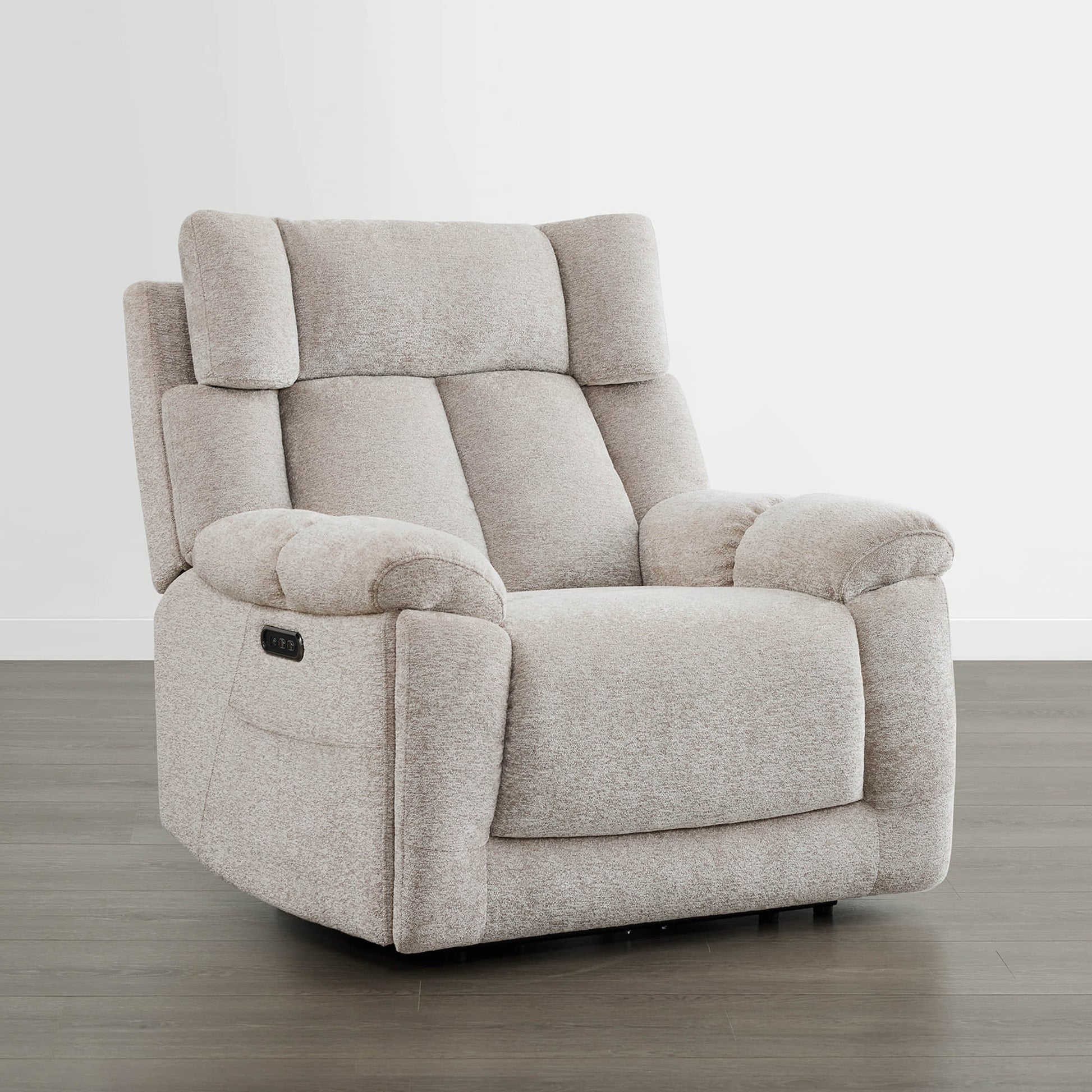 The Sonia Recliner, in beige fabric, features Bluetooth speakers and power lumbar support for ultimate comfort.