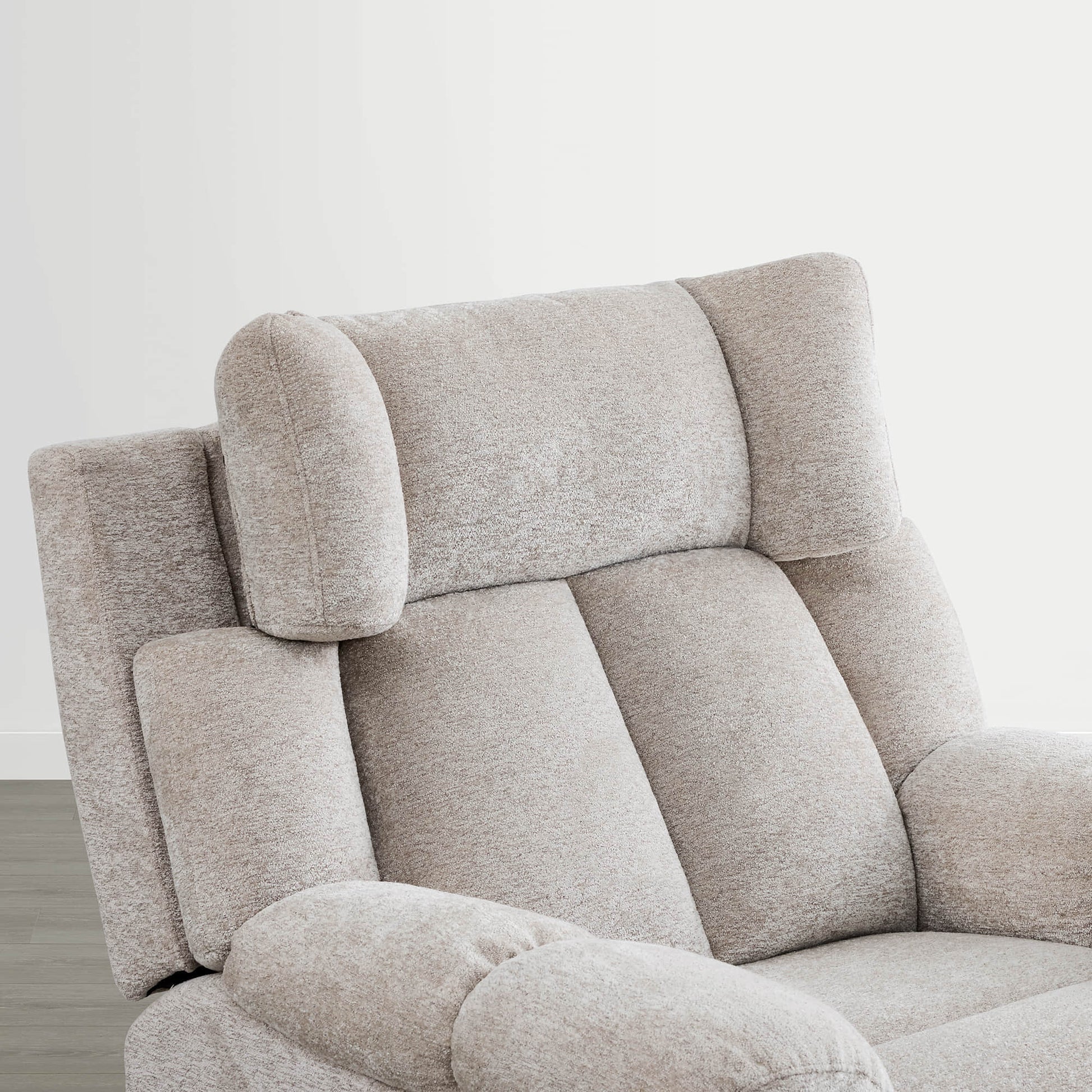 The Sonia Recliner, in beige fabric, offers Bluetooth speakers and power lumbar support for ultimate comfort.