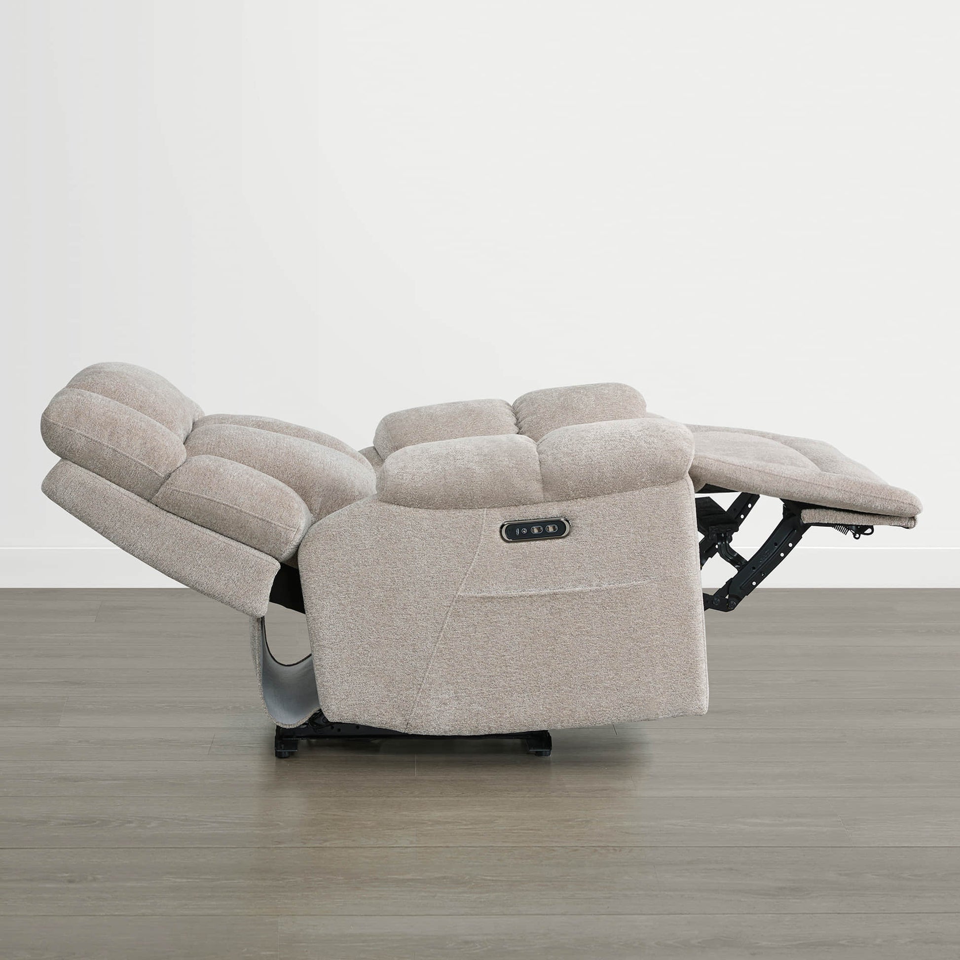 The Sonia Recliner, in beige fabric, features Bluetooth speakers and power lumbar support with an extended footrest.