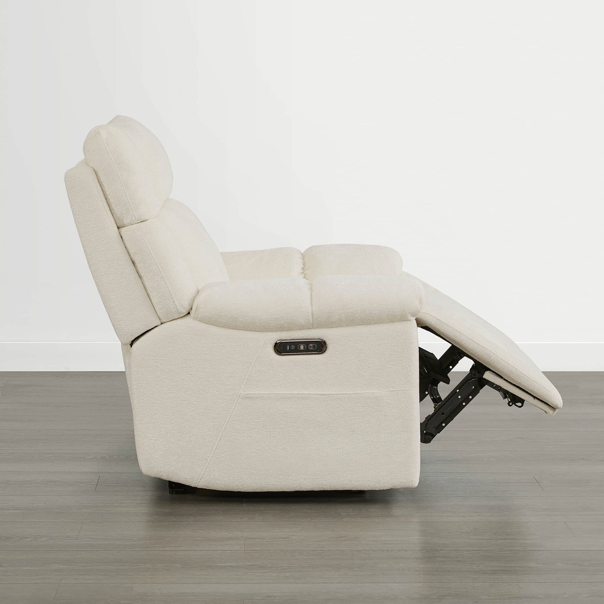 The Sonia Recliner, in cream fabric, offers Bluetooth speakers and power lumbar support for ultimate relaxation.