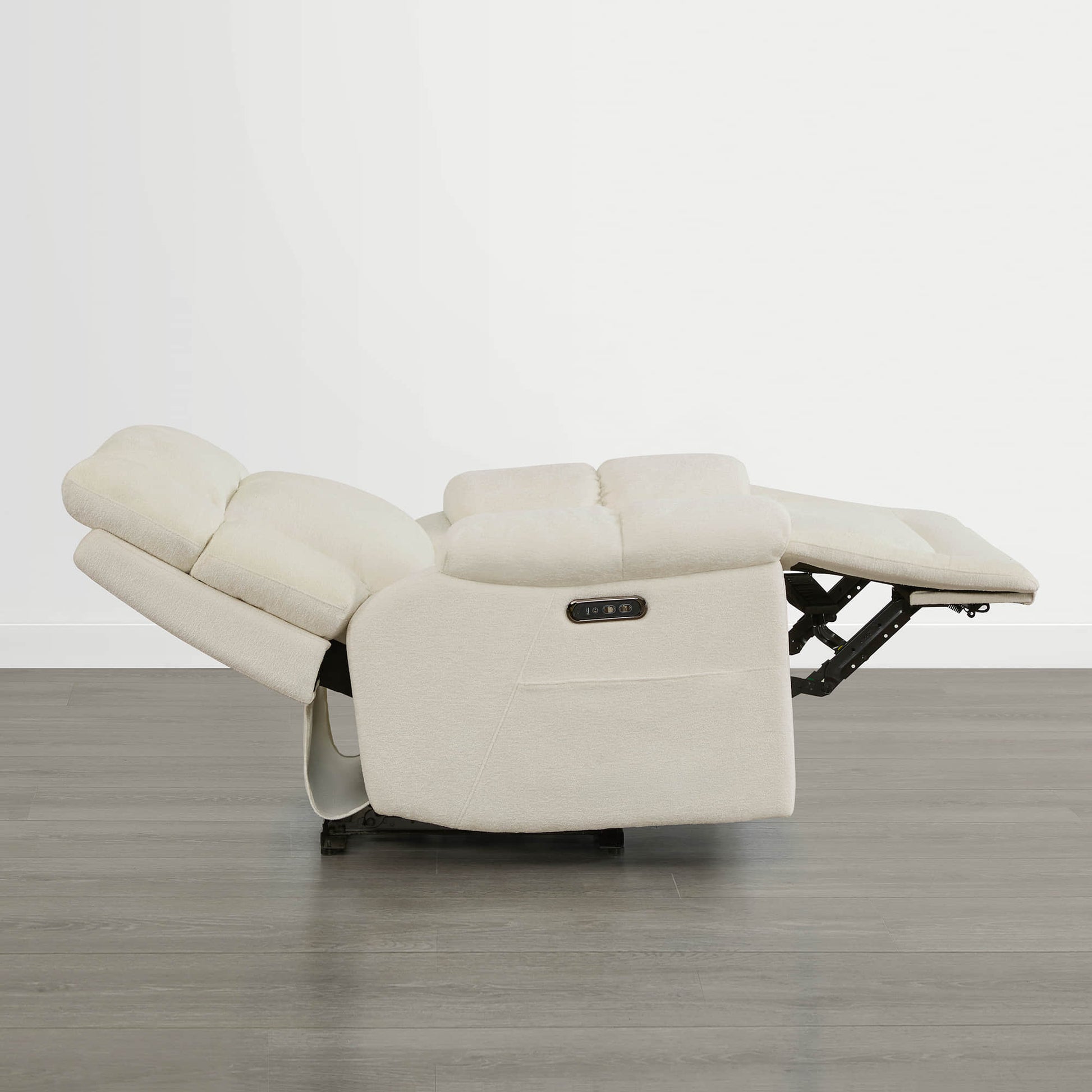 The Sonia Recliner, in cream fabric, features Bluetooth speakers and power lumbar support for ultimate comfort.