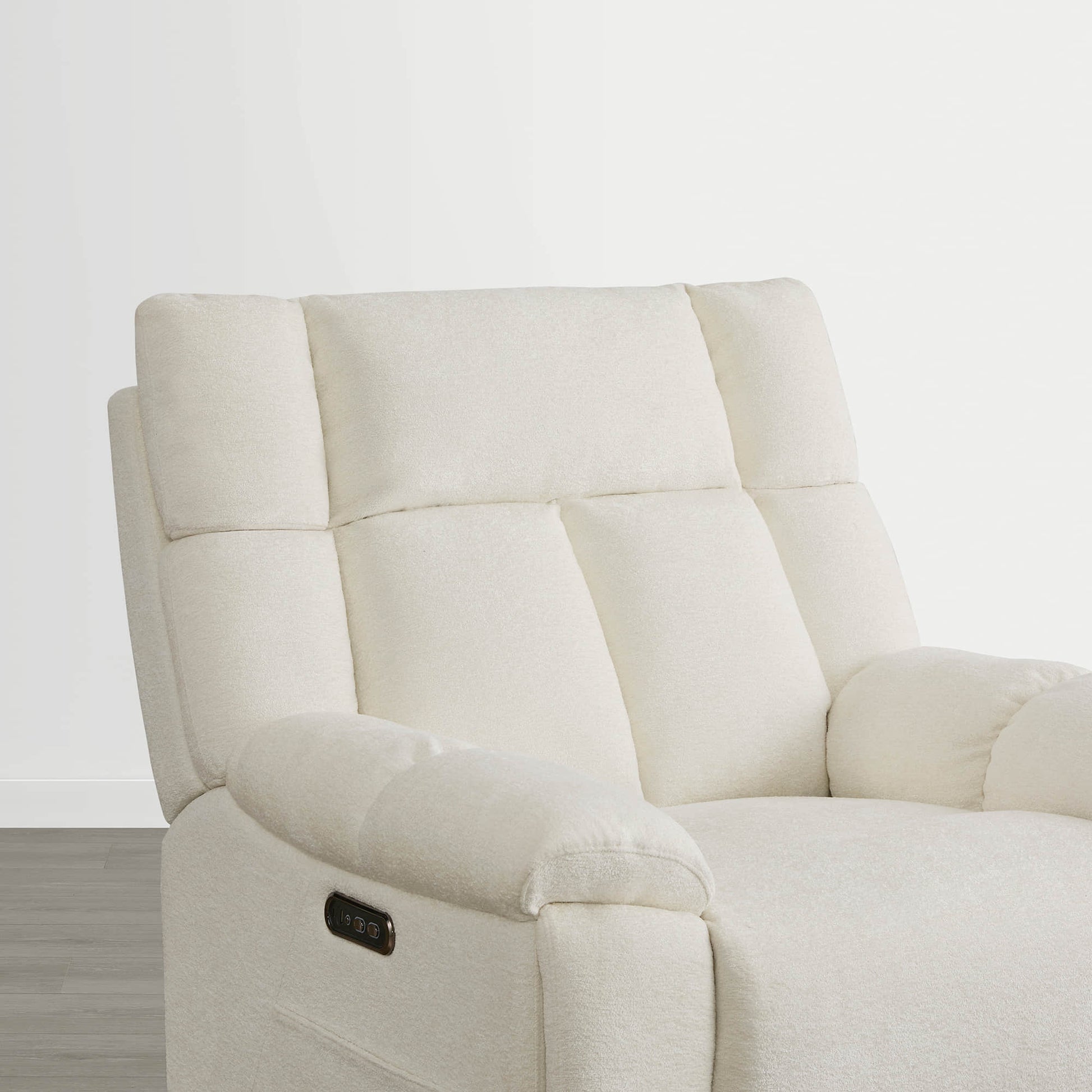 The Sonia Recliner, in cream fabric, features Bluetooth speakers and power lumbar support for ultimate comfort.
