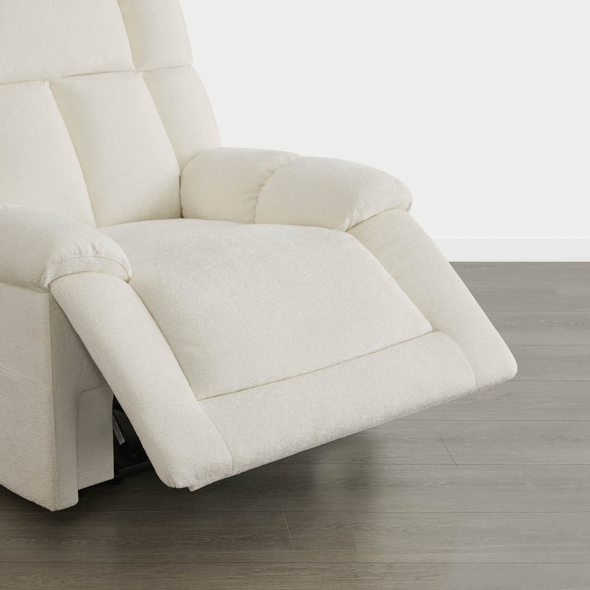 The Sonia Recliner, in cream fabric, features Bluetooth speakers and power lumbar support for ultimate comfort.