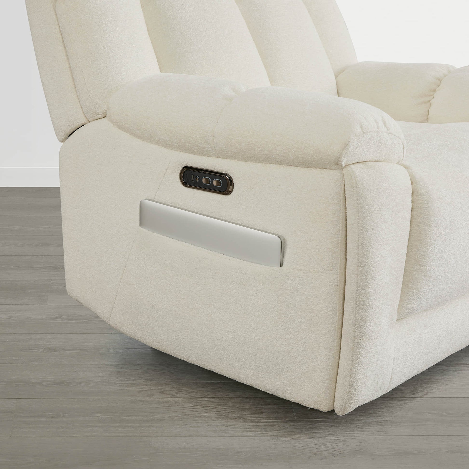 The Sonia Recliner, in cream fabric, features Bluetooth speakers and power lumbar support for ultimate comfort.