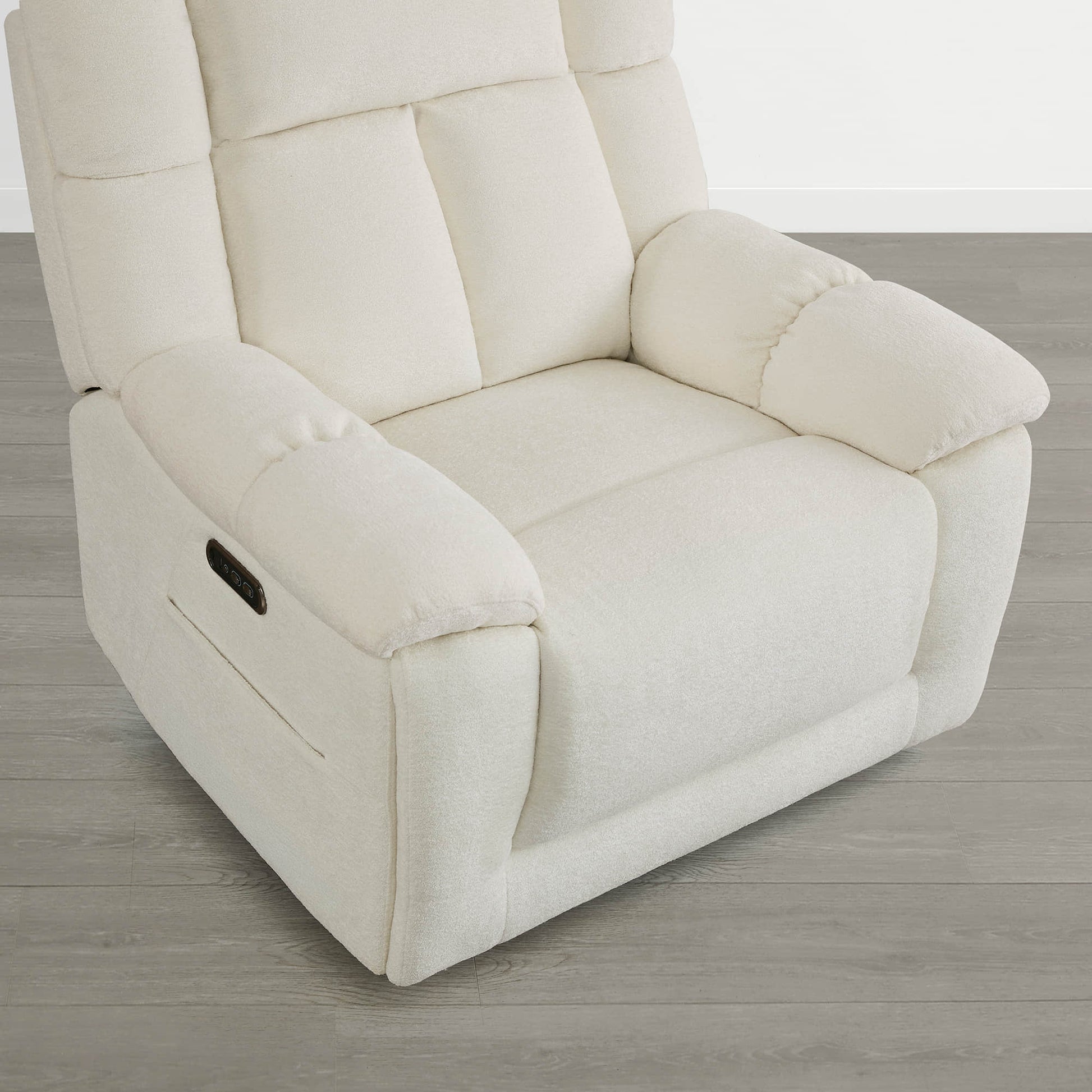 The Sonia Recliner, in cream fabric, features Bluetooth speakers and power lumbar support for ultimate comfort.