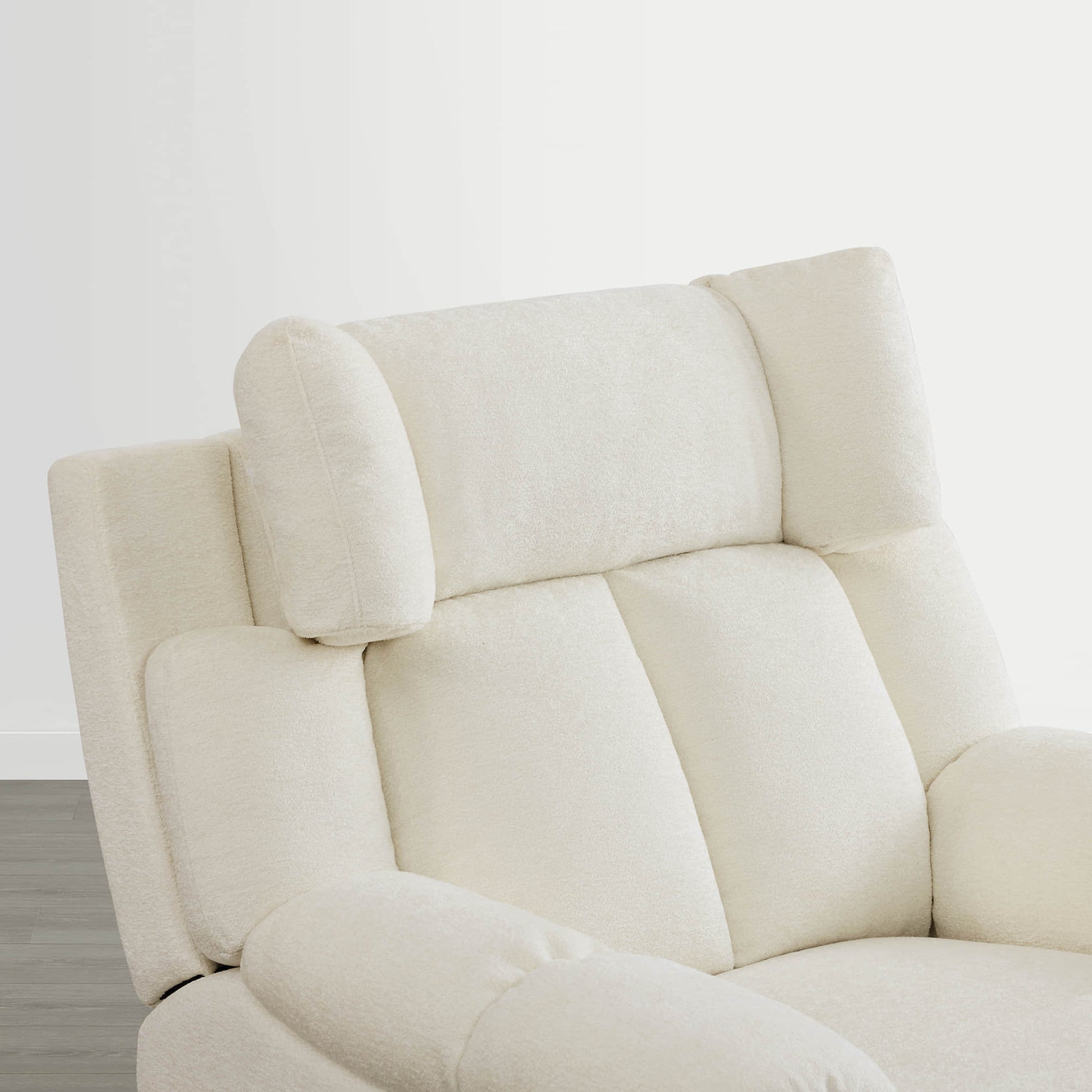 The Sonia Recliner, in cream fabric, offers Bluetooth speakers and power lumbar support for ultimate comfort.