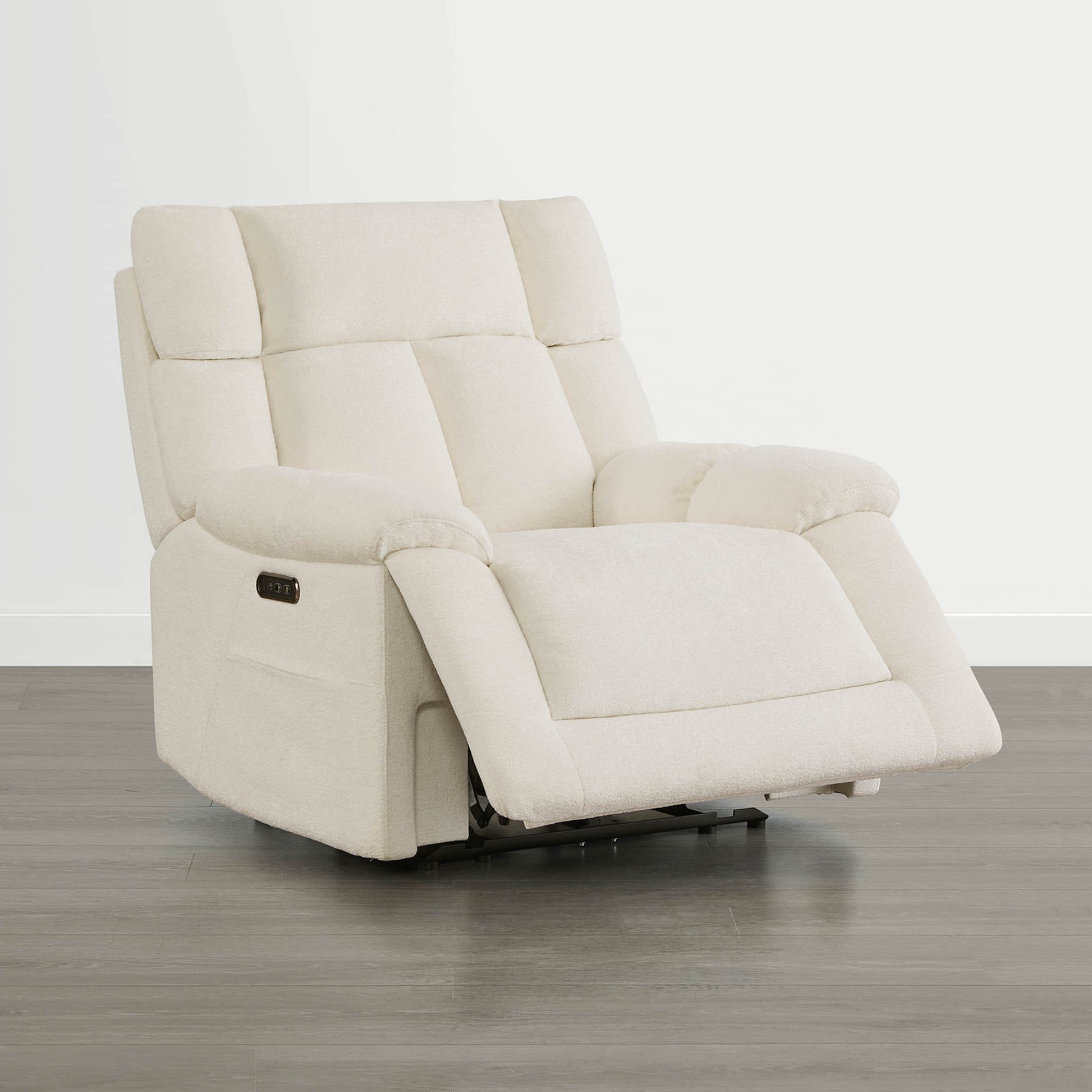 The Sonia Recliner, in cream fabric, features Bluetooth speakers and power lumbar support for ultimate comfort.