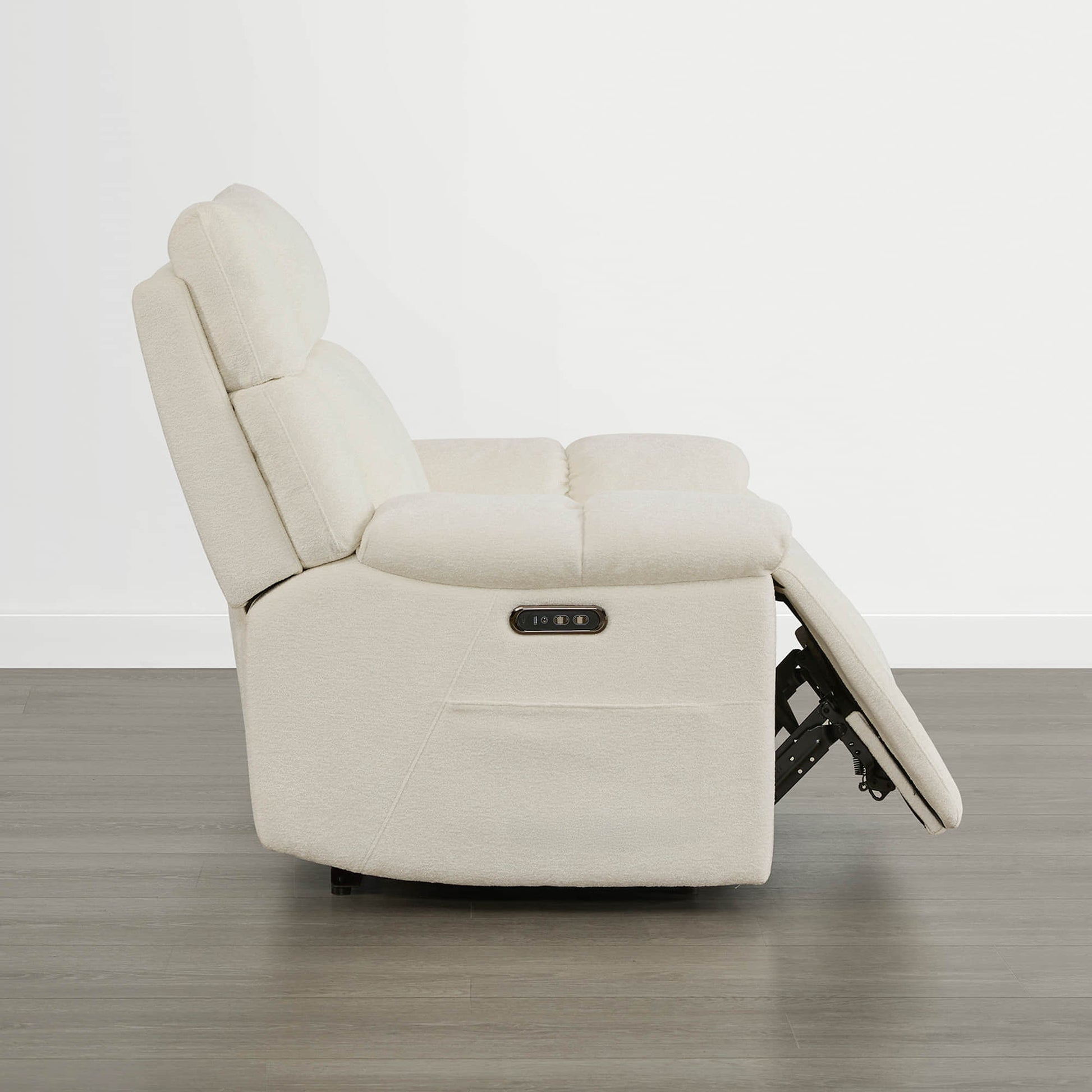 The Sonia Recliner, in cream fabric, offers Bluetooth speakers and power lumbar support for ultimate relaxation.