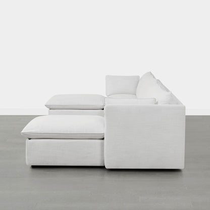 Side view of modern white modular sofa with chaise and plush cushions in minimalistic room - CHITA Living