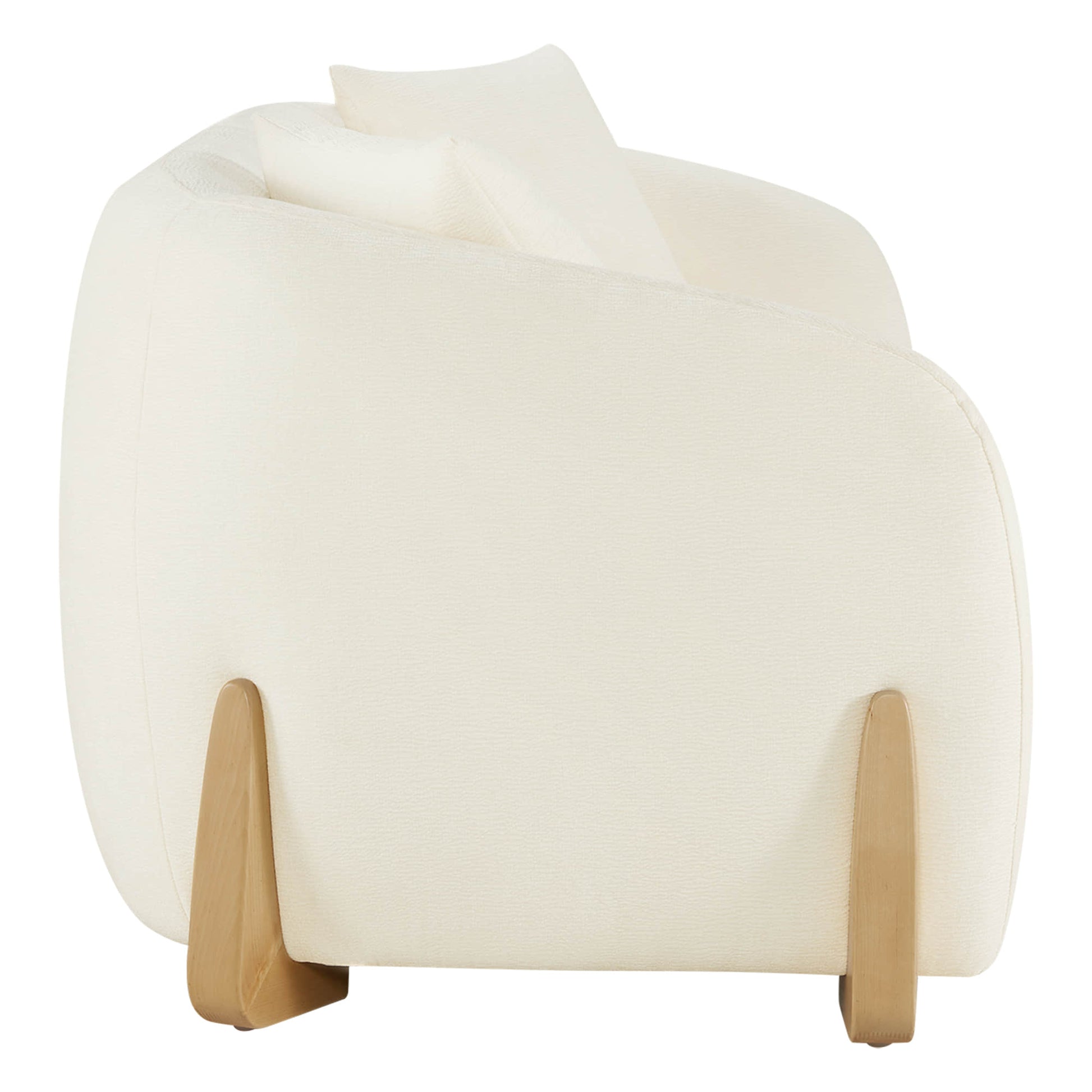 Side view of a modern sofa with curved design, cream upholstery, and wooden legs