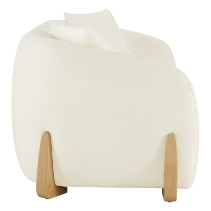 Side view of a modern sofa with curved design, cream upholstery, and wooden legs