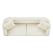 Top view of a modern sofa with cream upholstery and two cushions.