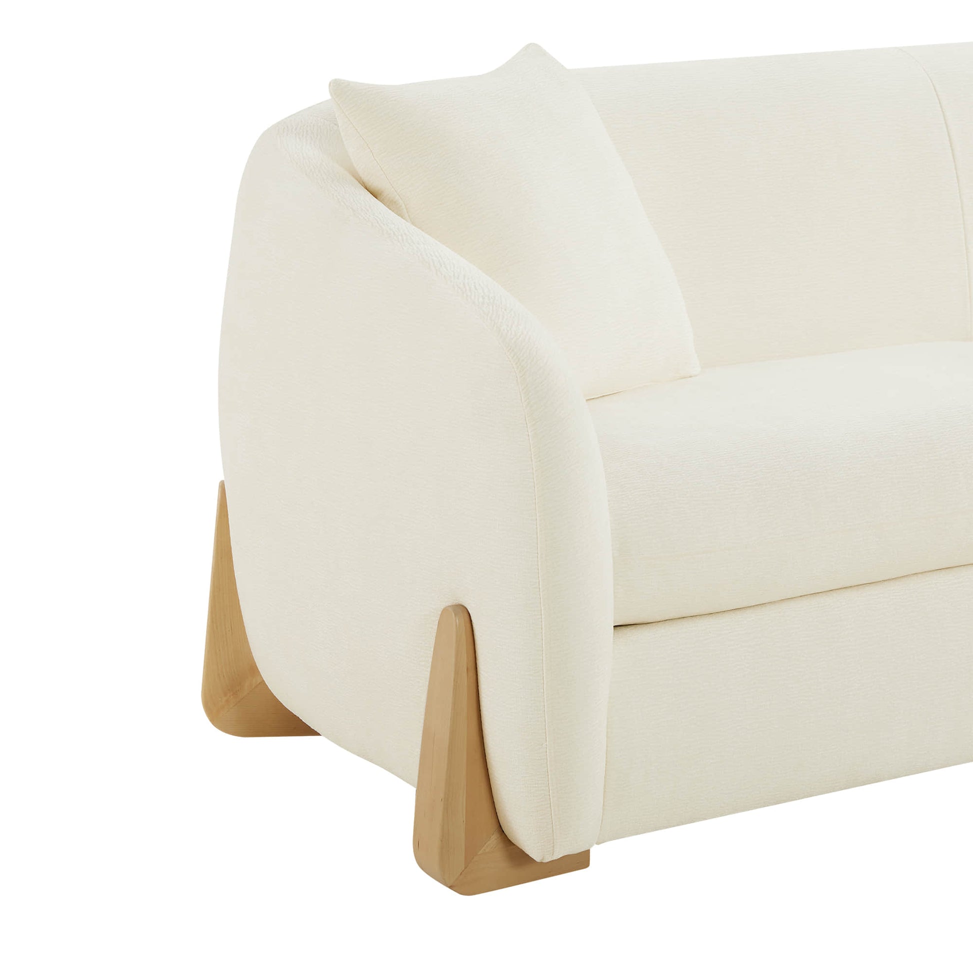 Side view of a modern sofa with cream upholstery, featuring a curved design and wooden legs.