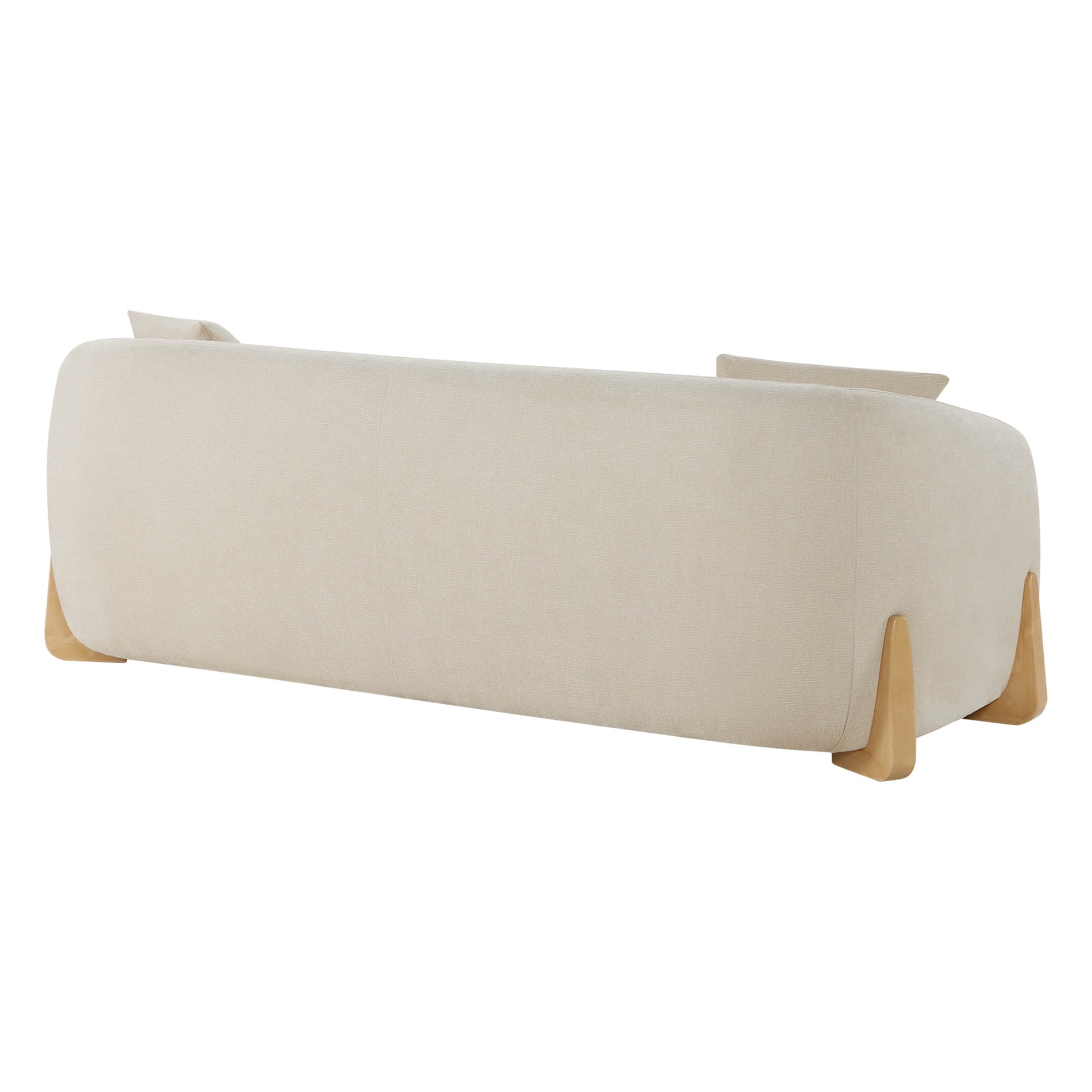 Angled rear view of a modern cream sofa with a rounded design and wooden legs, showing two cushions slightly visible above the backrest.