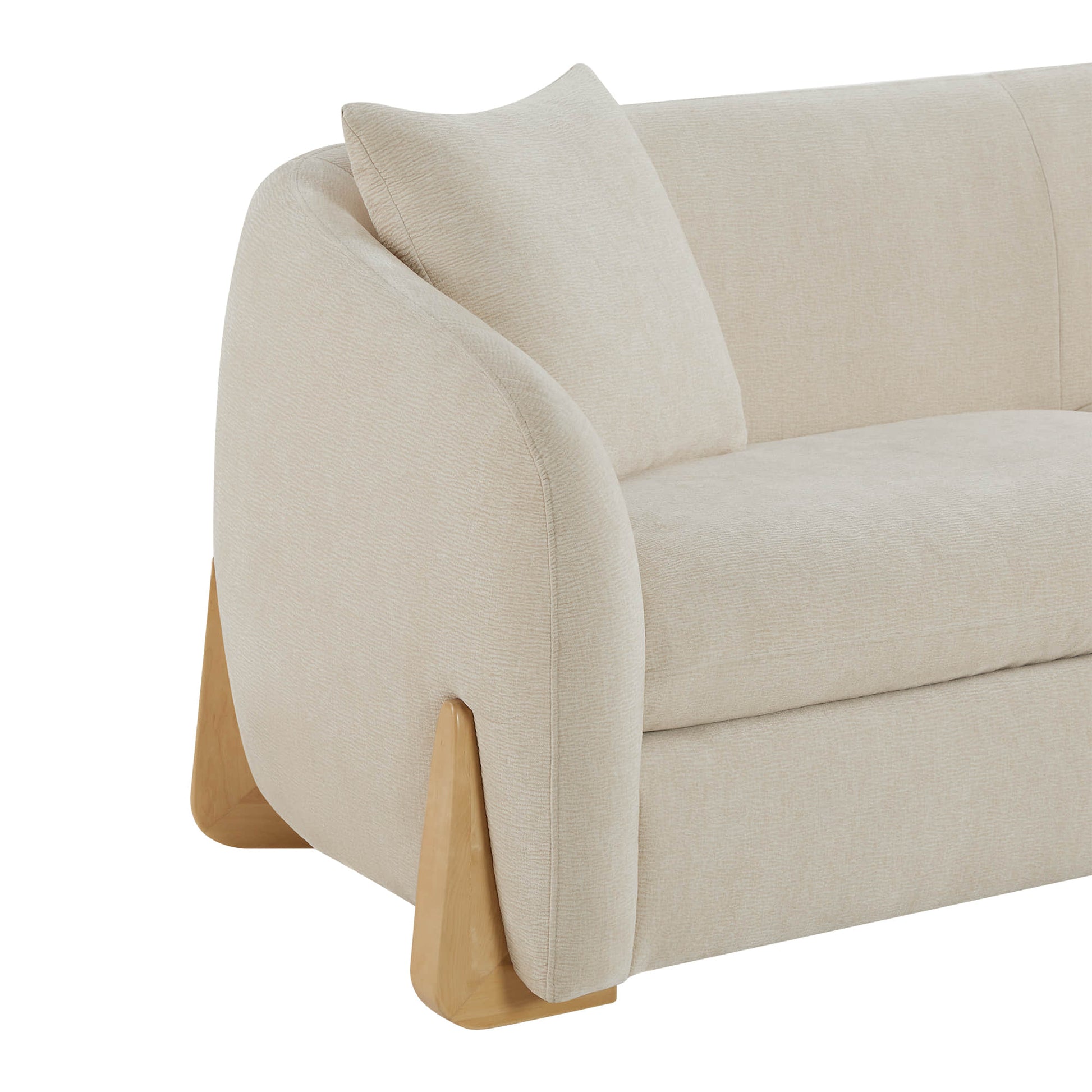 Close-up of a cream sofa arm with soft texture and wooden legs, featuring a cushion.