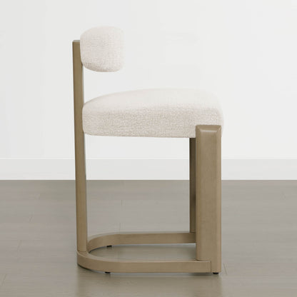 Troy Boucle Counter Stools with solid wood frames and cream bouclé upholstery provide stylish, modern seating.