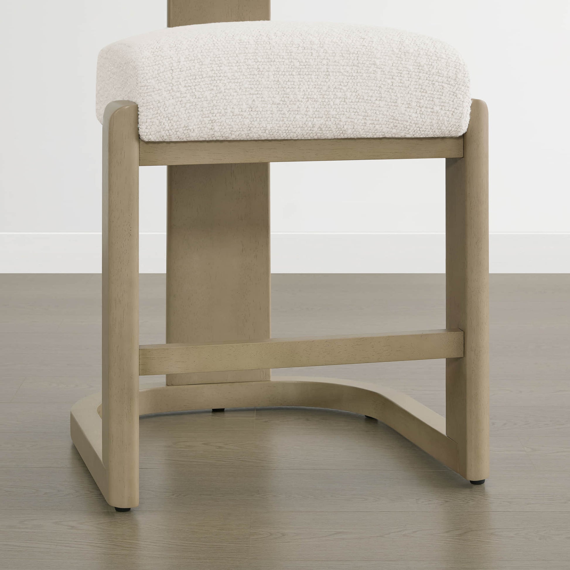 Troy Boucle Counter Stools with solid wood frames and cream bouclé upholstery offer a sleek, modern design.