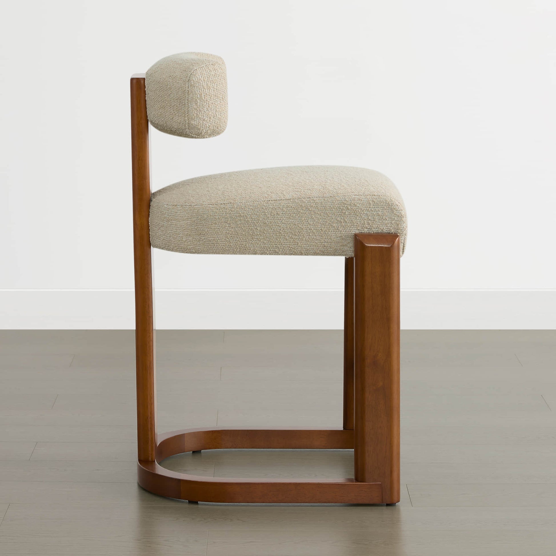 Troy Boucle Counter Stools feature solid wood frames and cream bouclé upholstery, combining modern design with comfort.