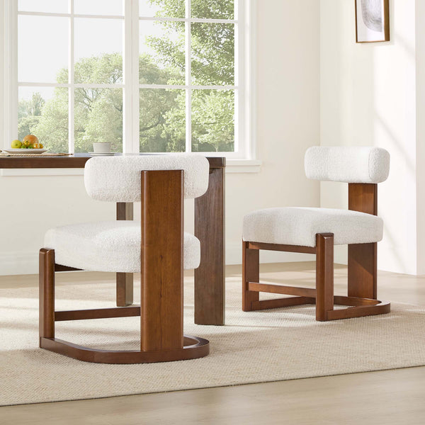 The Troy Boucle Dining Chair features a modern design with solid wood legs and a plush bouclé fabric seat.