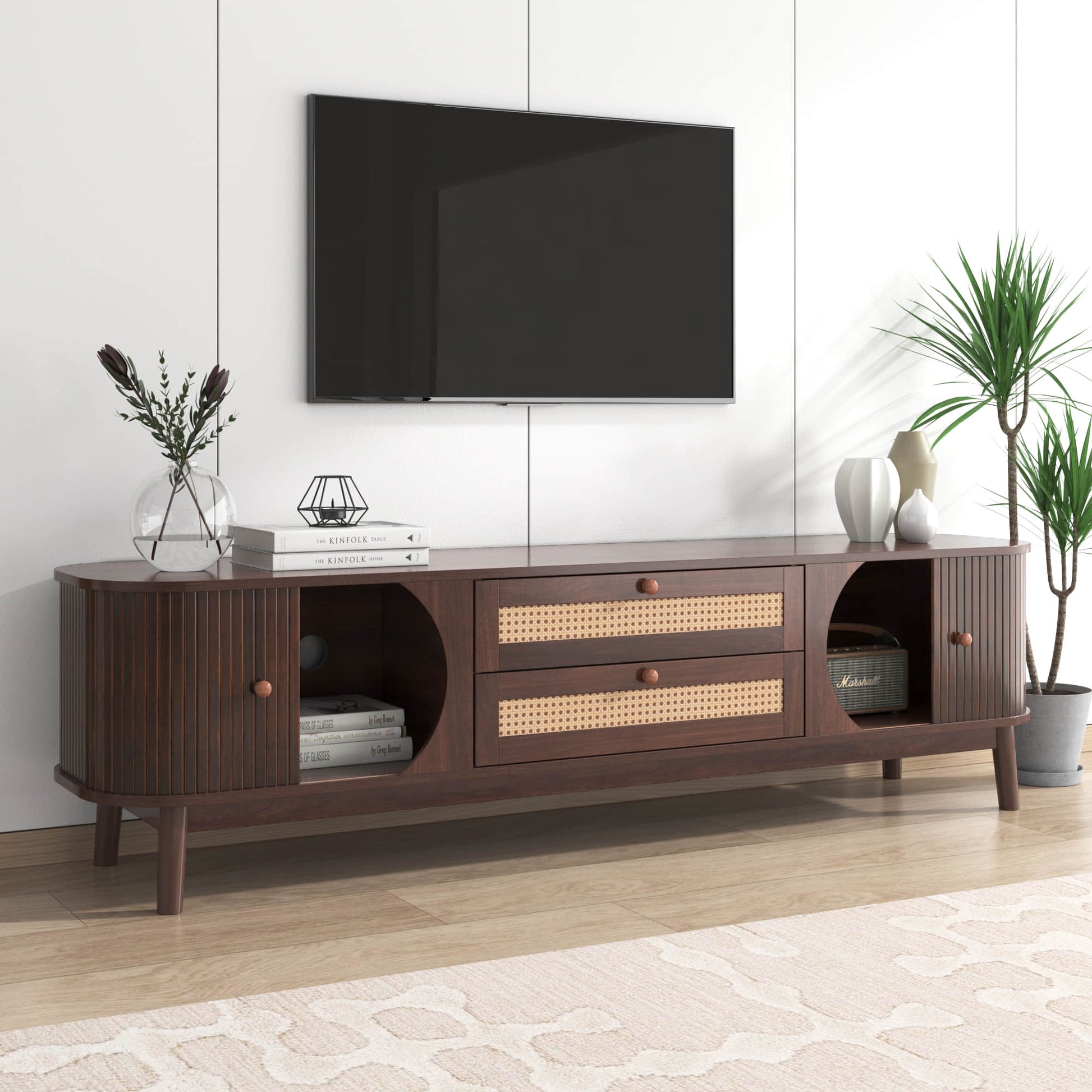 Modern tv stand dark wood with rattan drawers in a bright living room.