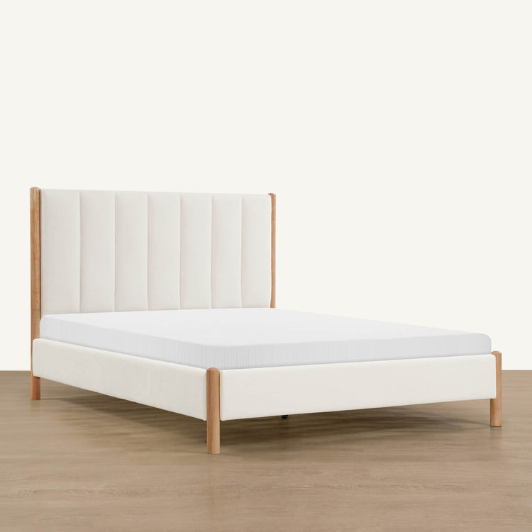 Contemporary upholstered platform bed with wooden legs and cushioned headboard - CHITA Living