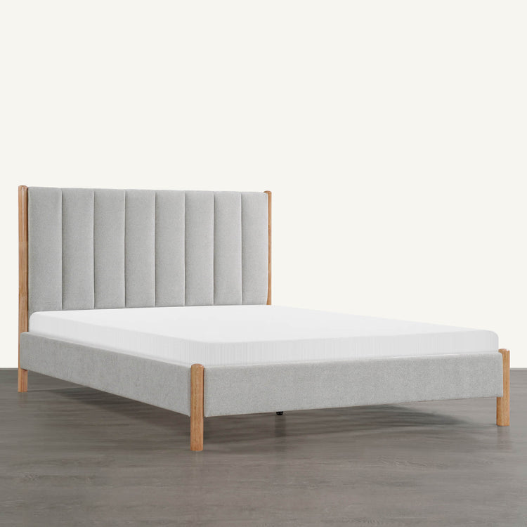 Serene upholstered platform bed with tufted light grey headboard and wooden legs - CHITA Living