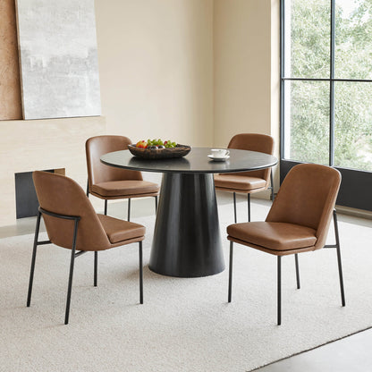 Golda Dining Chair, brown leather with black metal legs, set around a modern round dining table.